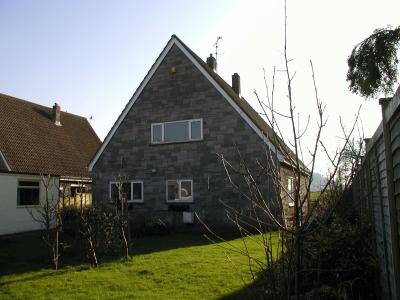 The front of the house after we moved in. You can just see the rust marks on the front bedroom window frame.
