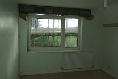 Gap above the back, right-hand bedroom window